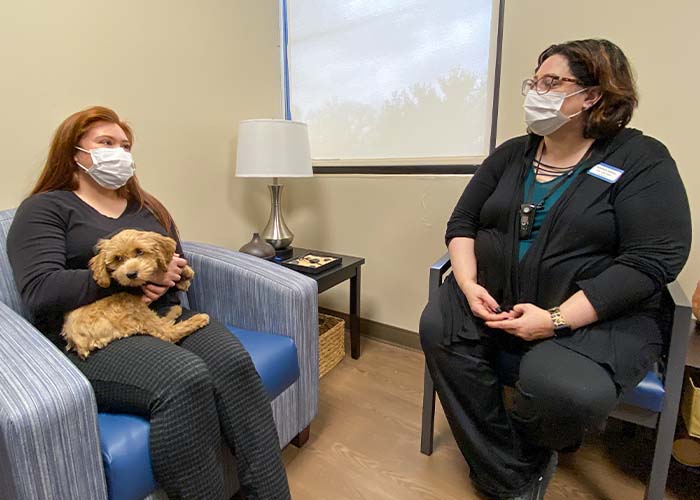 Veterinary Social Worker talking with a client.